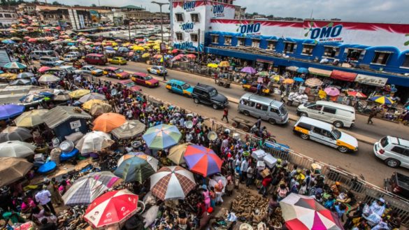 This image shows Onitsha open air market which is the largest market in west Africa. It shows how cars and public transport are moving within the open air market.